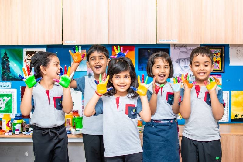 Children painting in the art studio at Harvest International School