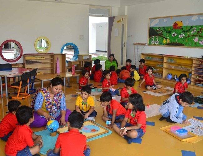 Young children learning together in a Montessori classroom at Harvest International School